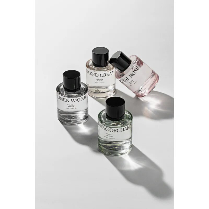 KUNDAL Objet Satin Glow Body Oil ápoló testolaj az intenzív hidratálásért illattal Linen Water 100 ml